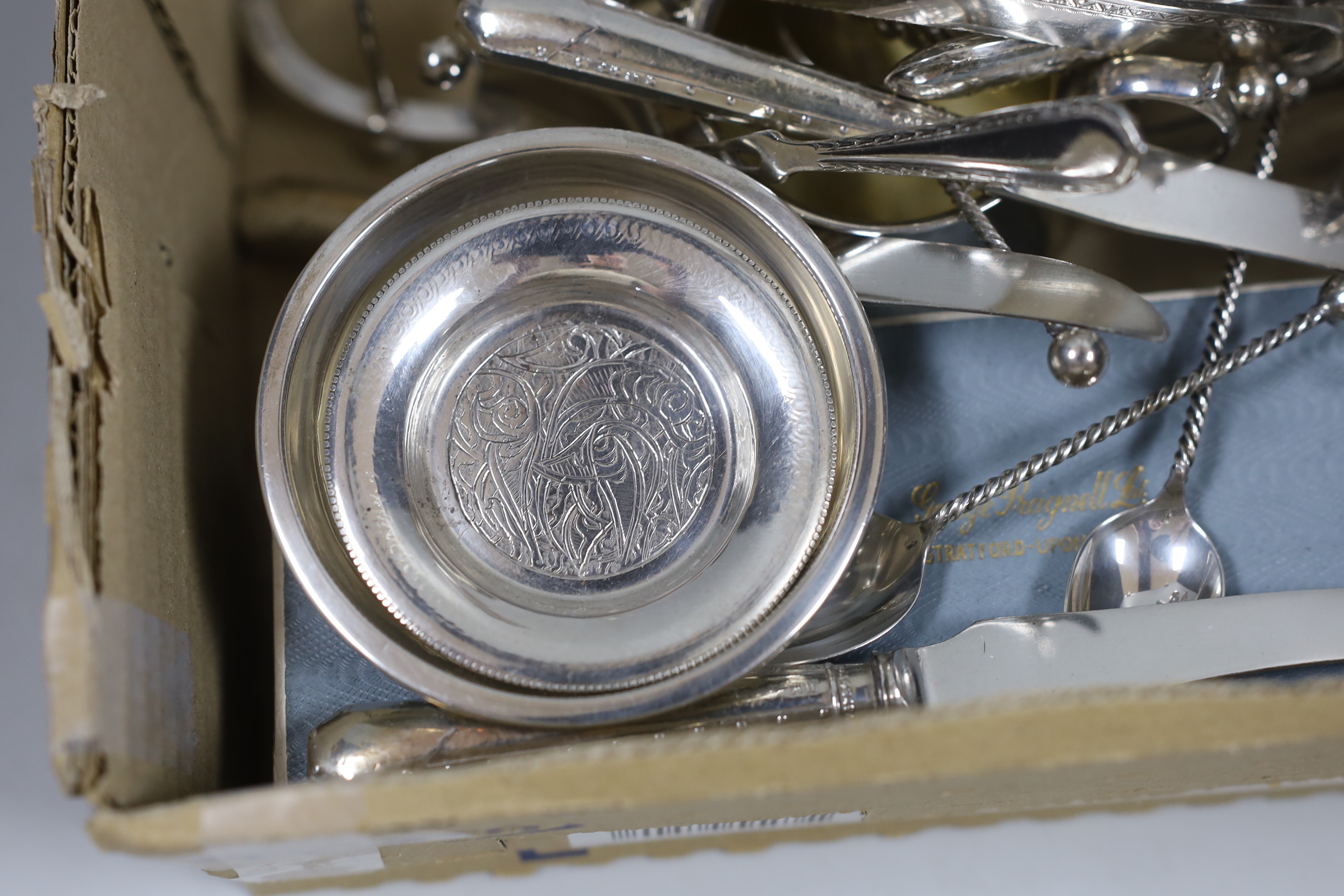 A small group of sundry small silver including a set of four napkin rings, cigarette box, sugar bowl, toastrack, scent bottle, 19th century white metal needle case, Egyptian white metal dishes and assorted flatware inclu